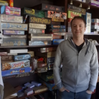 Robert Daviau in front of his personal collection of board games, IronWall Games, West Longmeadow, Massachusetts, 2016